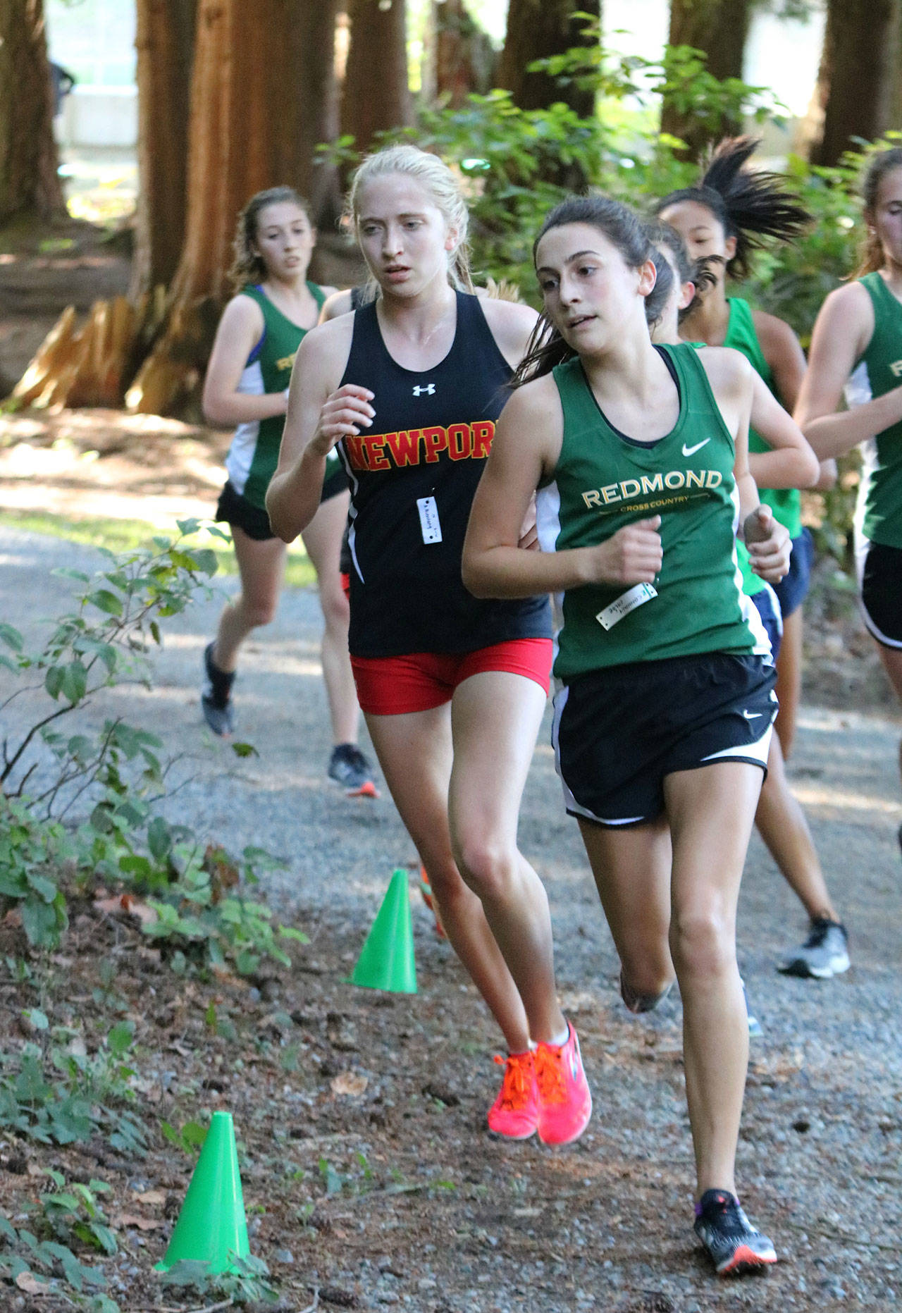 Redmond High sophomore Chloe Connolly, right, took second in 19 minutes, 50 seconds versus Newport and Woodinville. Newport senior Alyssa Bienfang, left, won the race in 19:49. Andy Nystrom / staff photo