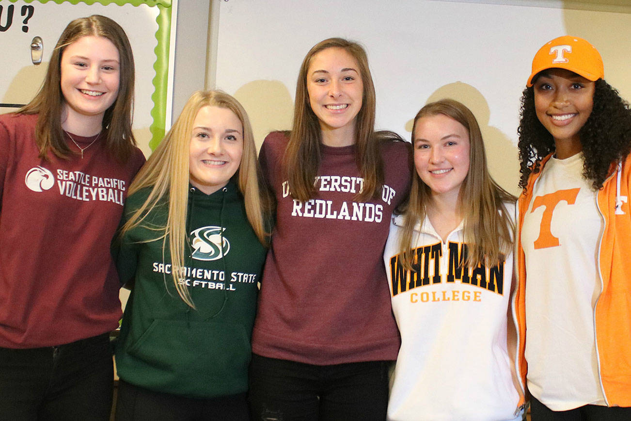 Redmond High athletes sign on to play college ball