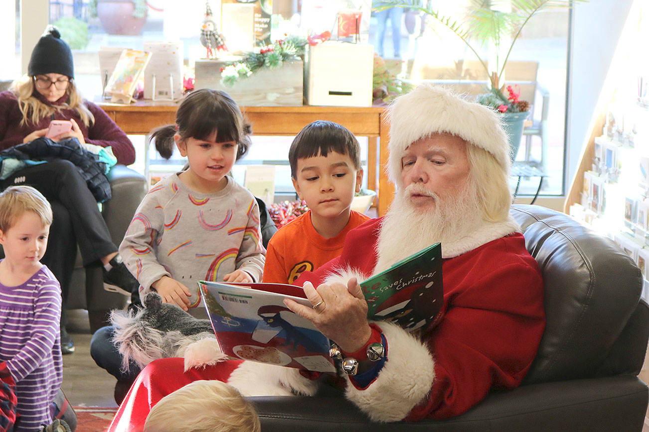 Santa reads to youngsters at story time at Brick and Mortar Books in Redmond Town Center on Dec. 4. Stephanie Quiroz/staff photo.