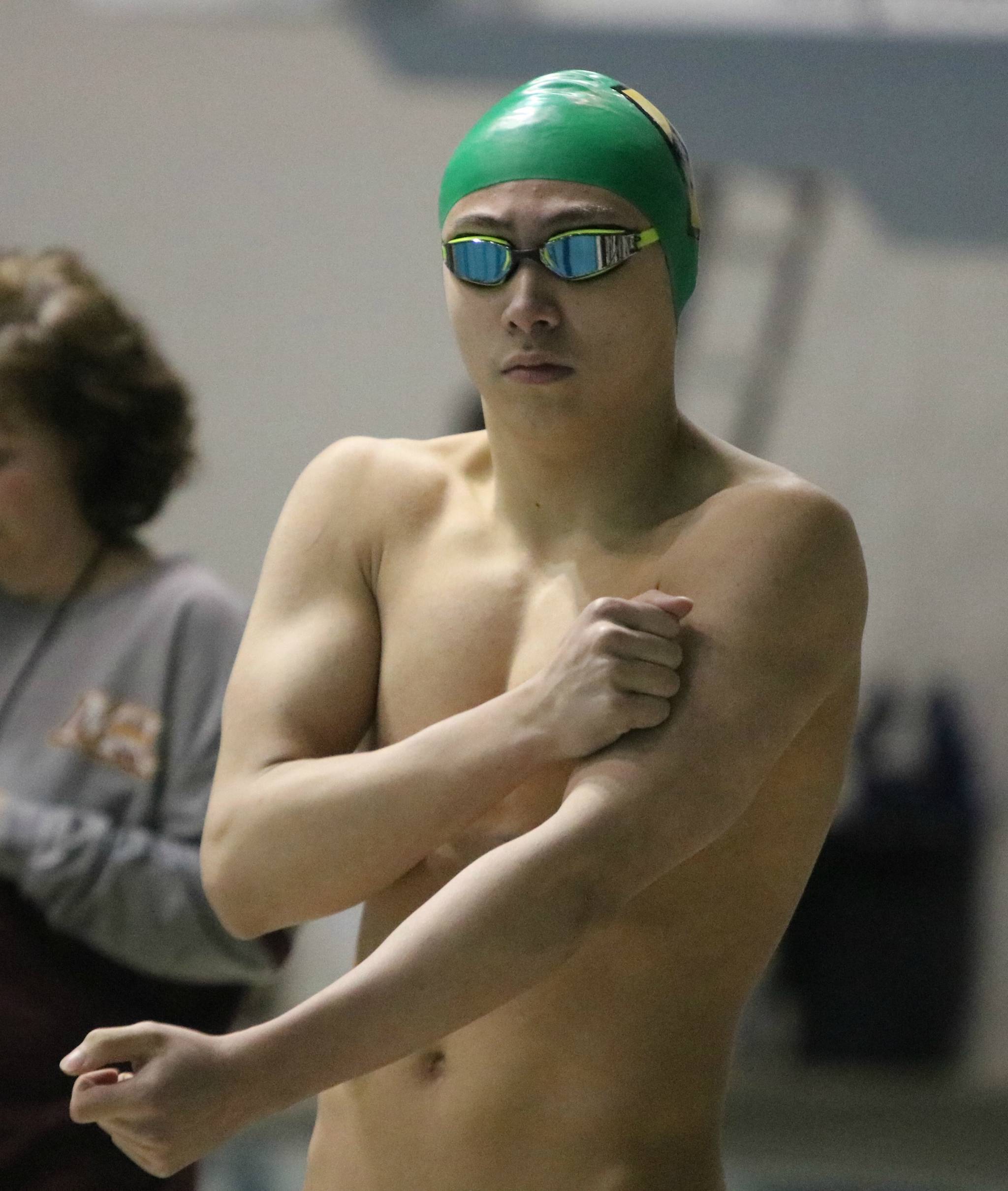 Redmond High’s Aidan Blackmon gets pumped up for the 100 fly. Andy Nystrom / staff photo