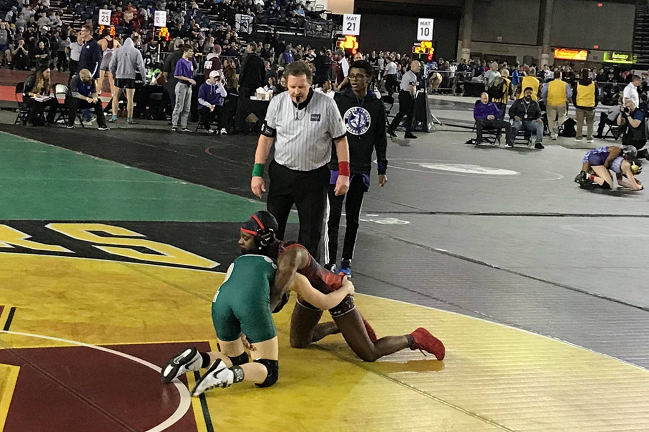 Redmond Mustangs junior Molly Williams, left, competes against Yelm senior Phoenix Dubose, right, in the girls 115-pound tournament semifinal matchup on Feb. 16 at the Mat Classic. Williams earned third place in the 115-pound weight class. Shaun Scott, staff photo