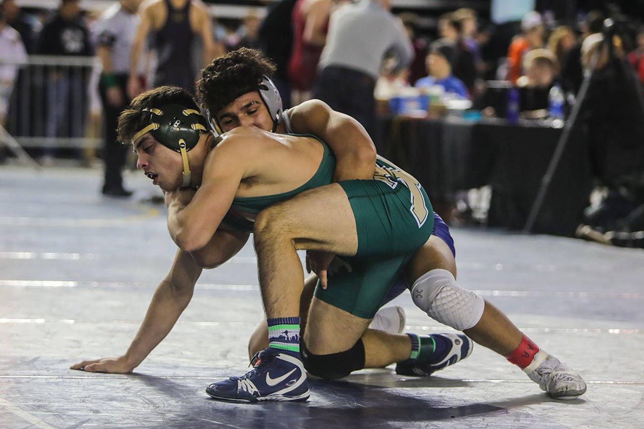Redmond Mustangs senior Jeremy Hernandez, left, earned sixth place in the Class 4A 145-pound weight class at the Mat Classic on Feb. 16 at the Tacoma Dome. Photo courtesy of Don Borin/Stop Action Photography