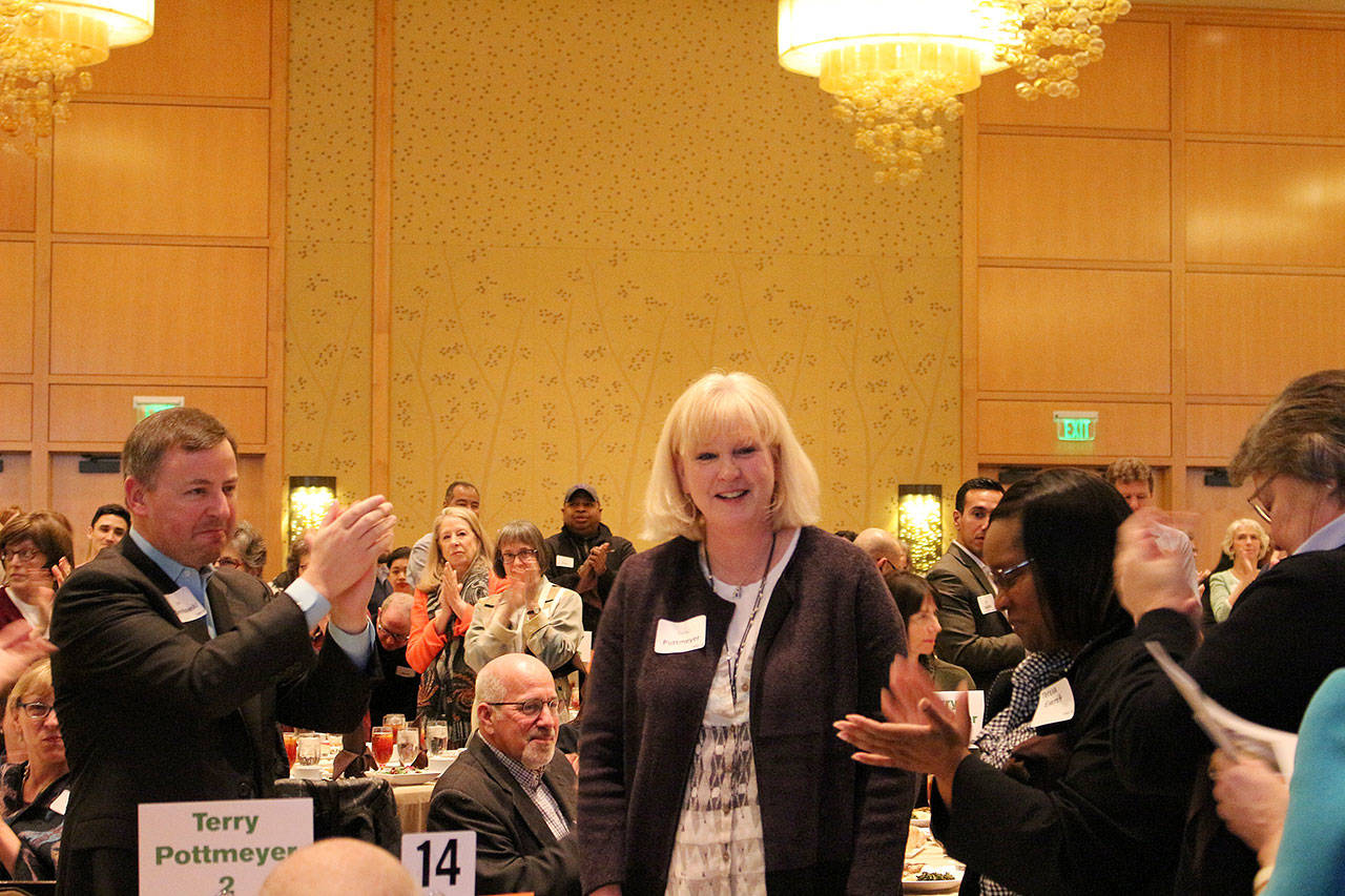 Outgoing Friends of Youth CEO, Terry Pottmeyer, receives a standing ovation at the Celebration of Youth luncheon. Madison Miller/staff photo