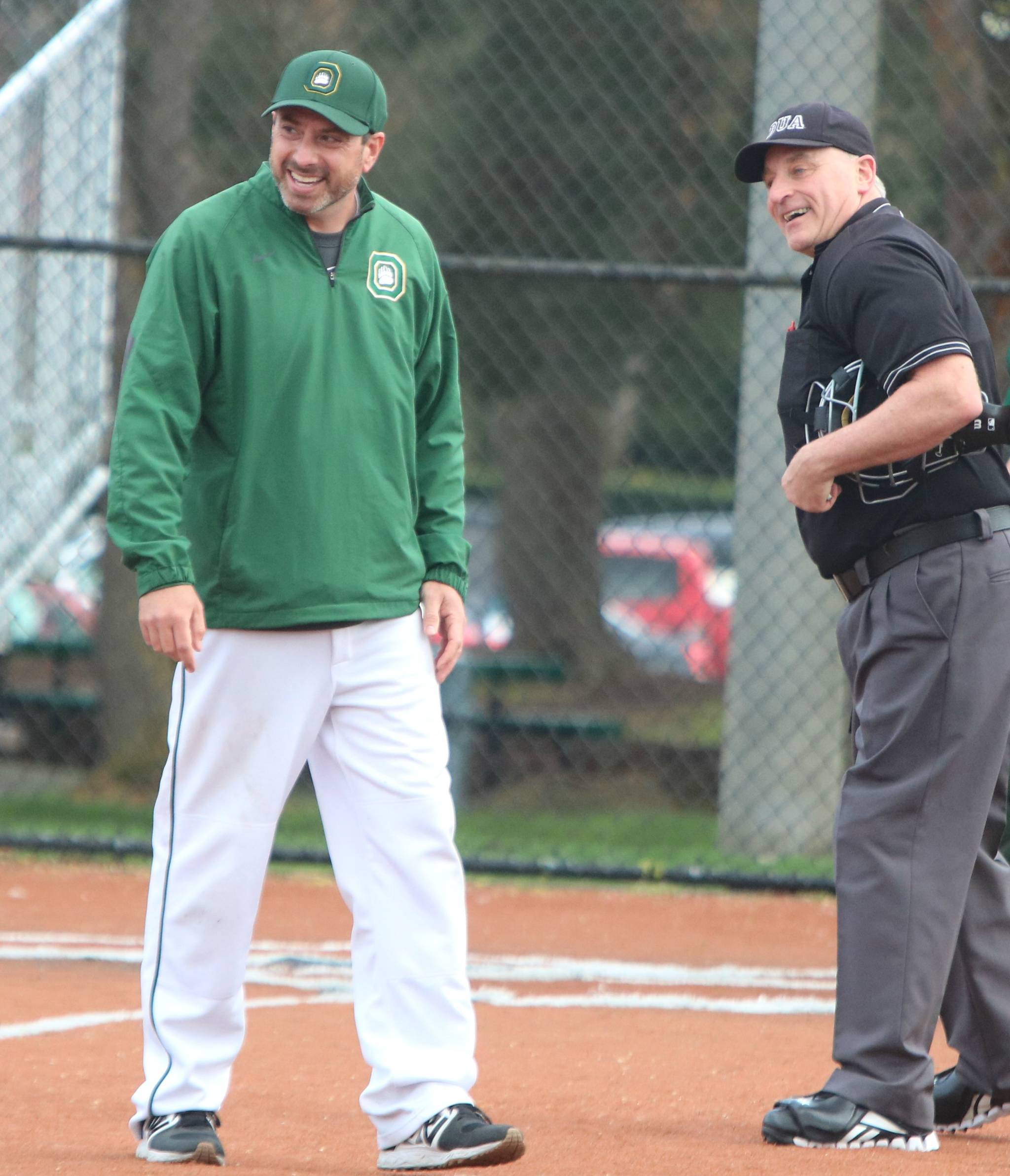 Growls head coach Mike Davidson shares a laugh with the umpire. Andy Nystrom / staff photo