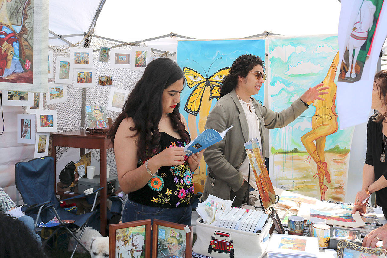 Stephanie Quiroz/staff photo                                 An attendee visits a booth at the Cinco de Mayo festival at the Downtown Park on May 5.