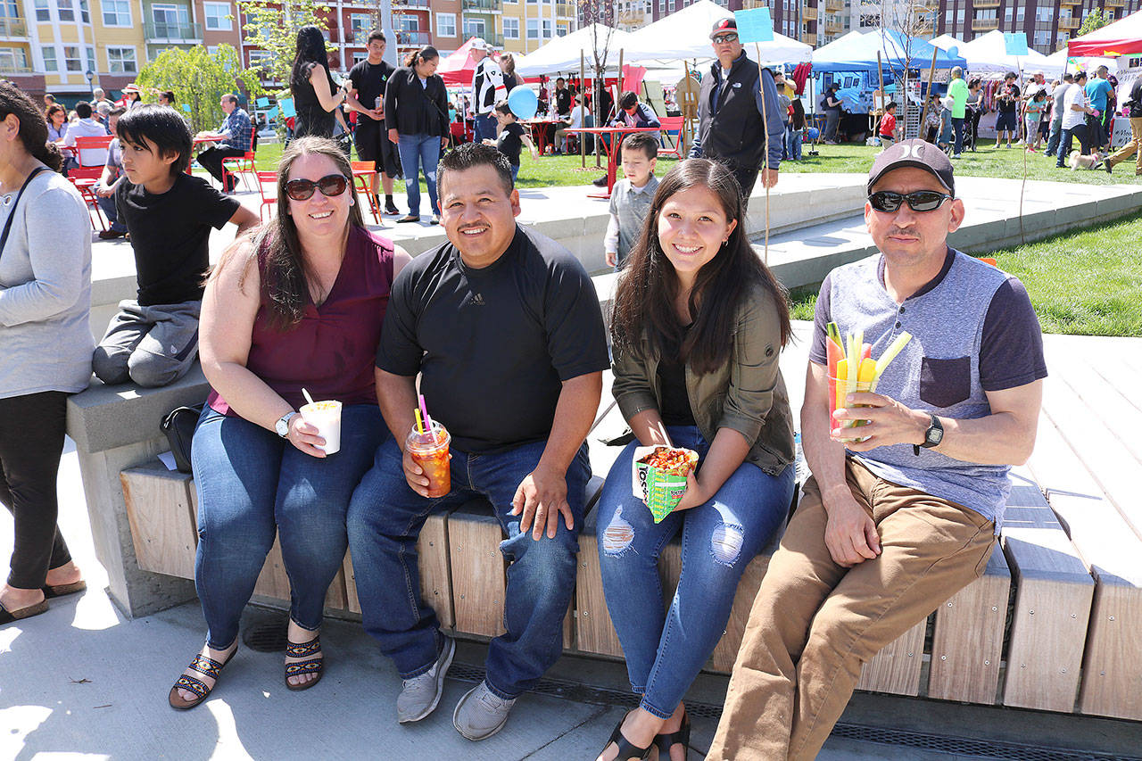 From left: Redmond residents Susana Ramirez, Sergio Ramirez, and Isabel and Jose Basurto eating the traditional Mexican foods at the Cinco de Mayo festival at the Downtown Park on May 5.