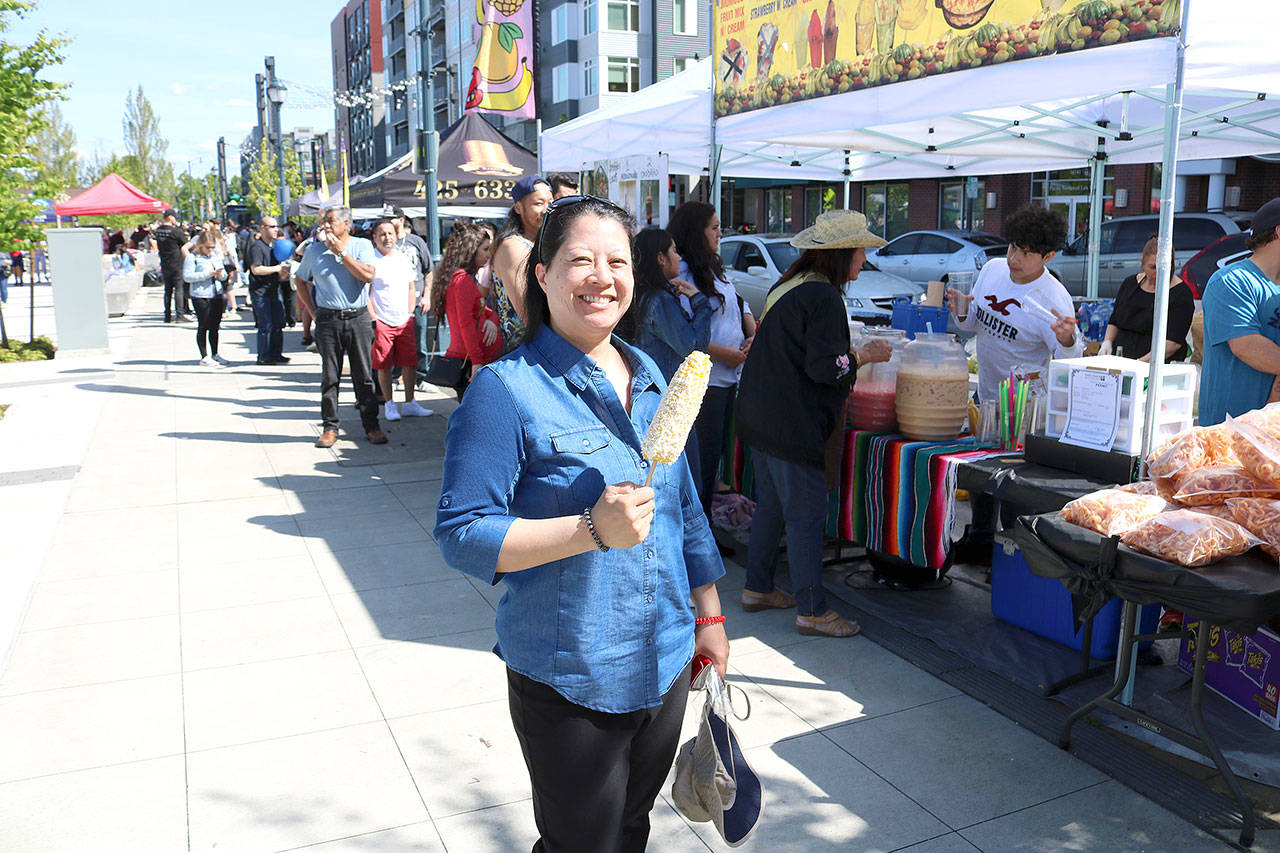 Elizabeth Lee from Redmond eating Mexican grilled corn at the Cinco de May festival at the Downtown Park on May 5. Stephanie Quiroz/staff photo
