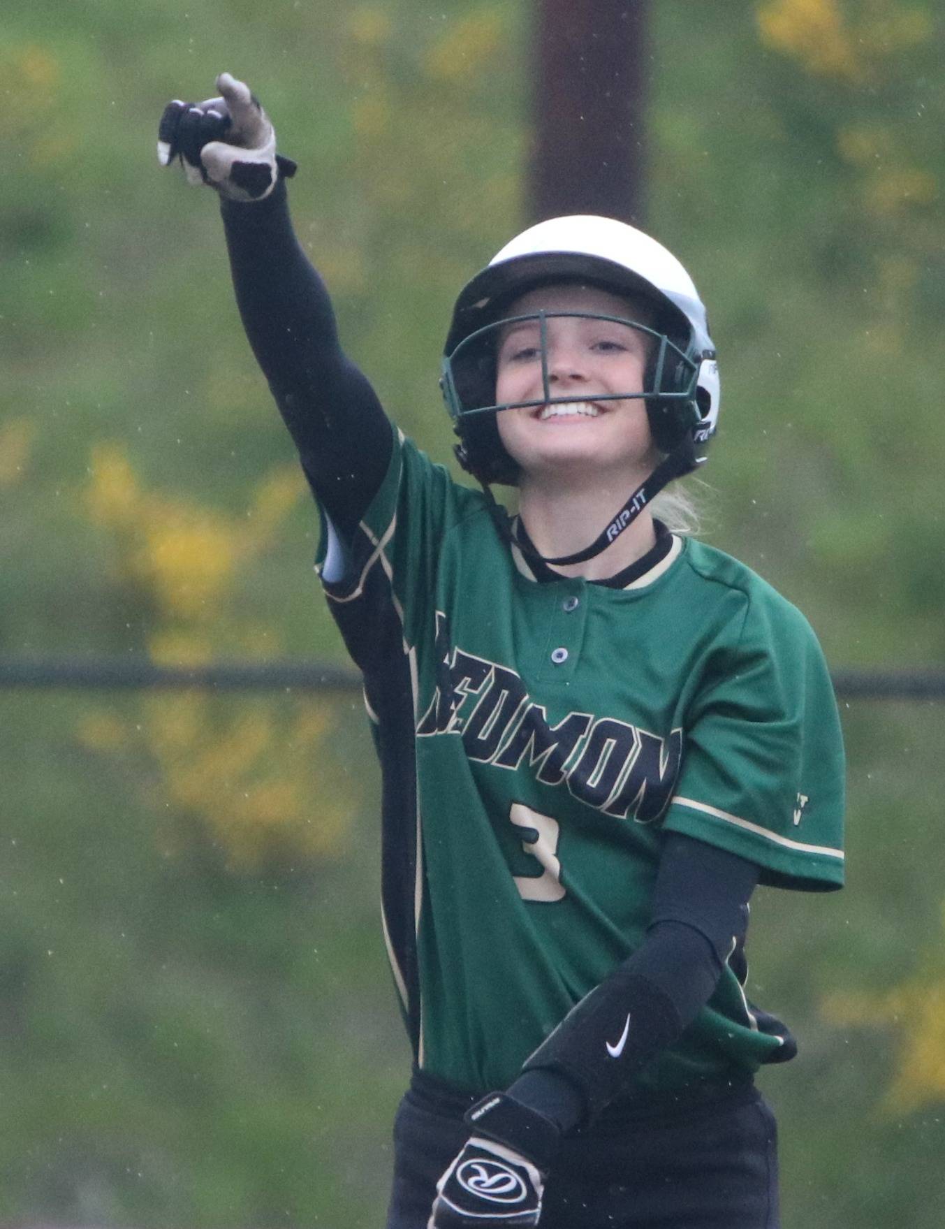 Camille Eaton points to her teammates on the bench after she doubled against Newport. Andy Nystrom / staff photo