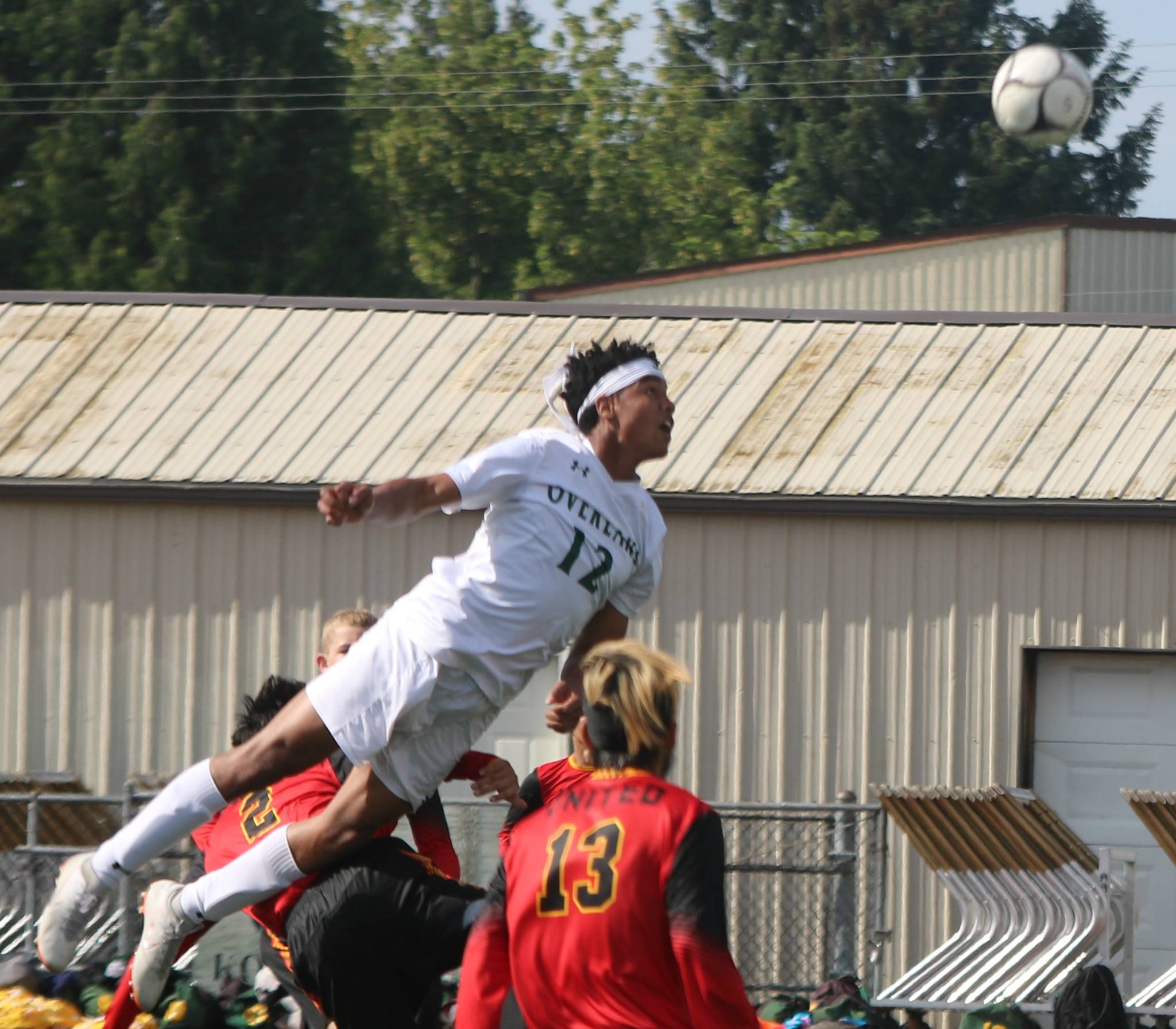 Overlake’s Trey Rudolph flies high for a header in the semifinals. Andy Nystrom/ staff photo