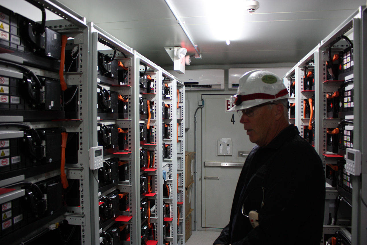 Puget Sound Energy controls engineer Paul Jusak shows the interior to one of four units at the Glacier Batter Storage Project. The shipping container is filled with lithium-ion batteries which are basically modified electric bus batteries. Aaron Kunkler/staff photo