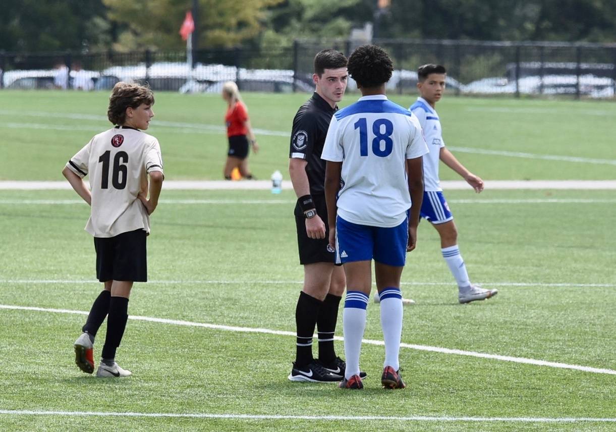 Jordan Price speaks with a player during a soccer match. Photo courtesy of Washington Youth Soccer