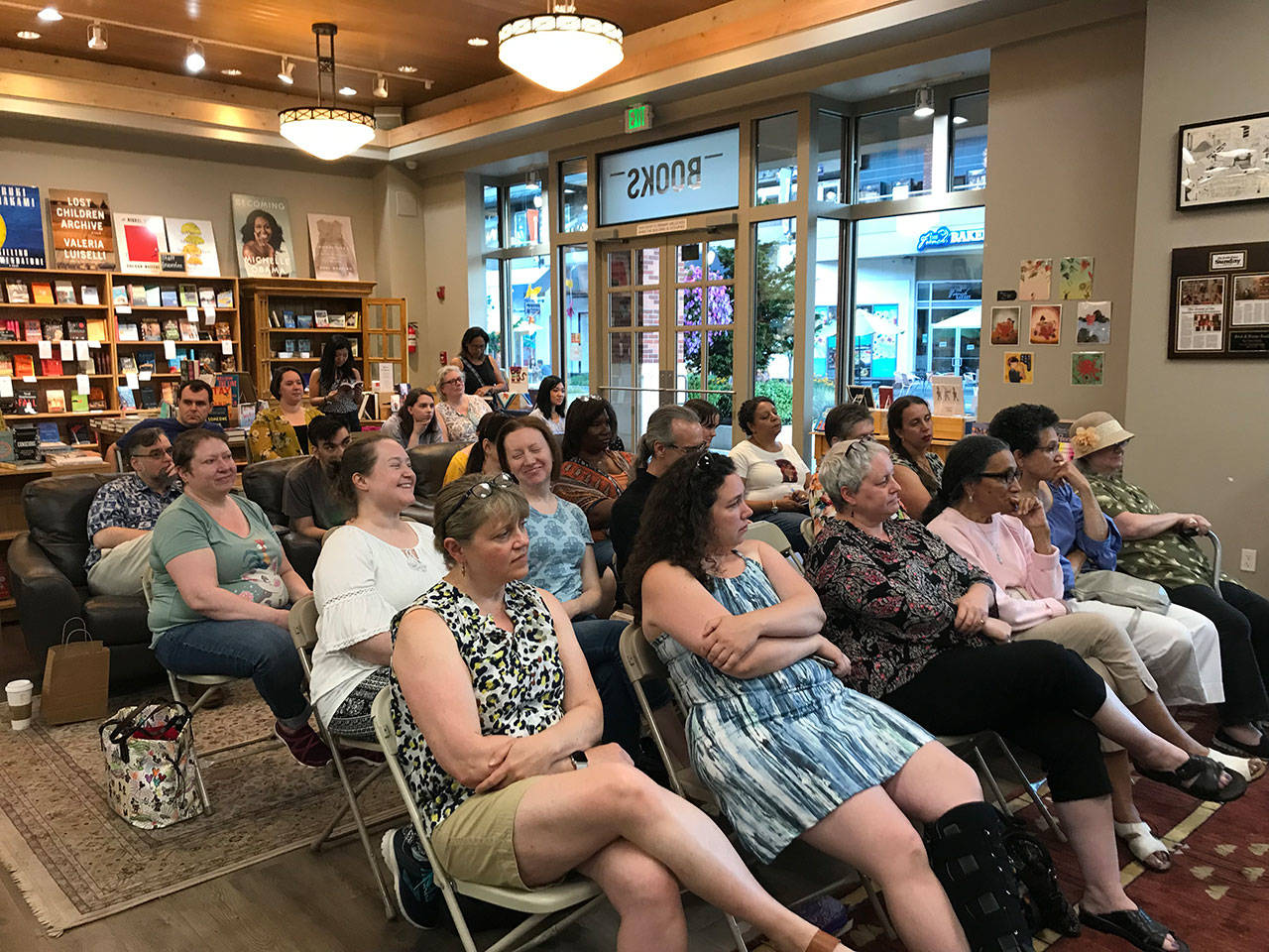 The audience at Brick & Mortar Books in Redmond listens to authors discussing the importance of representation in stories.