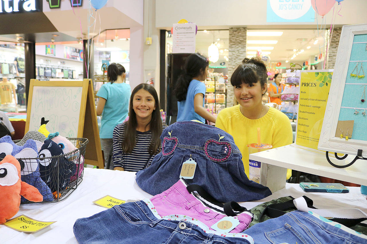 Redmond sister duo, Sofia (left) and Aaliya Osmanbhoy sold jewelry, up-cycled jean purses and stuffies at the business fair on Aug. 31. Stephanie Quiroz/staff photo