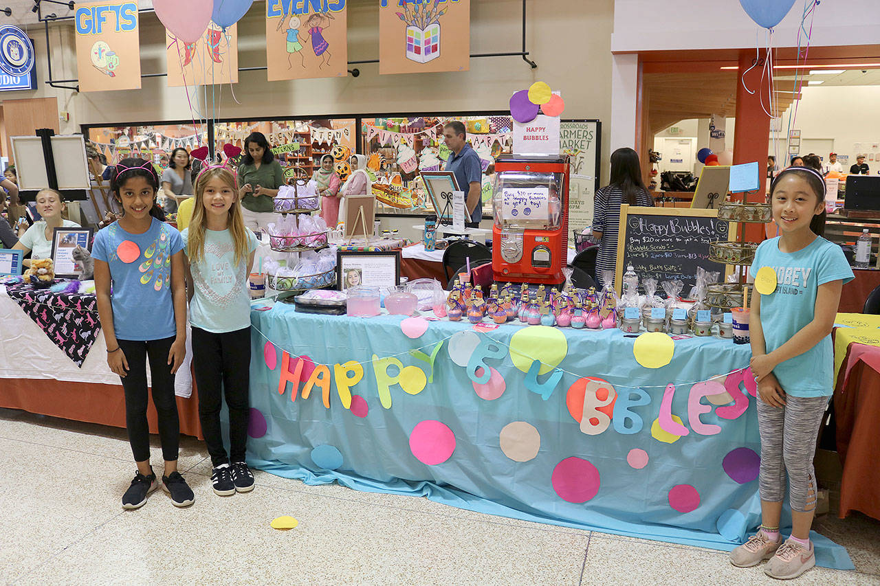 From left, Kaavya Manam, Emerson Schrider and Ellen Chang of Happy Bubbles sold handmade bath and body products at the Children’s Business Fair in Bellevue on Aug. 31. Stephanie Quiroz/staff photo