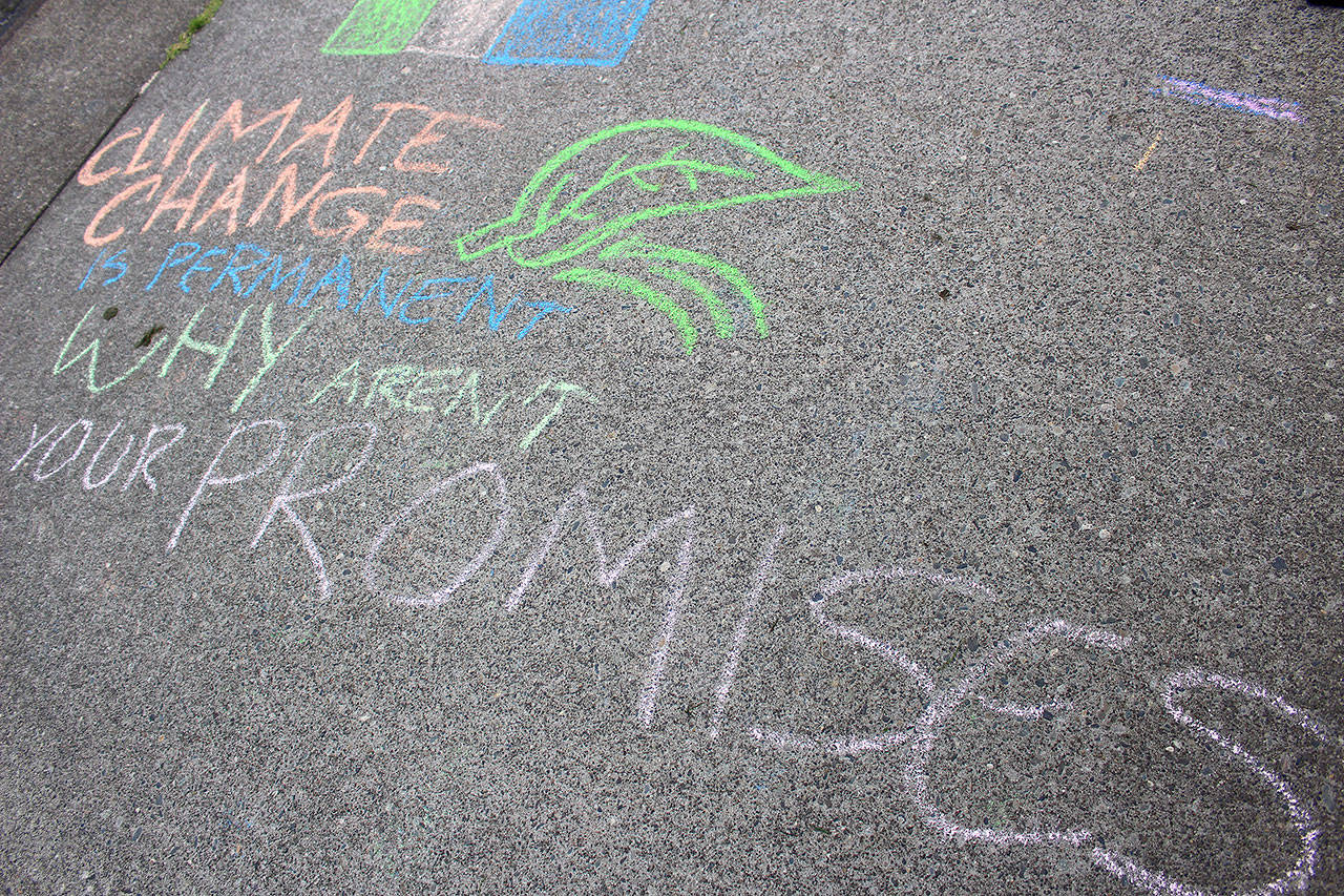 A chalk message “Climate change is permanent. Why aren’t our promises?” Madison Miller/staff photo