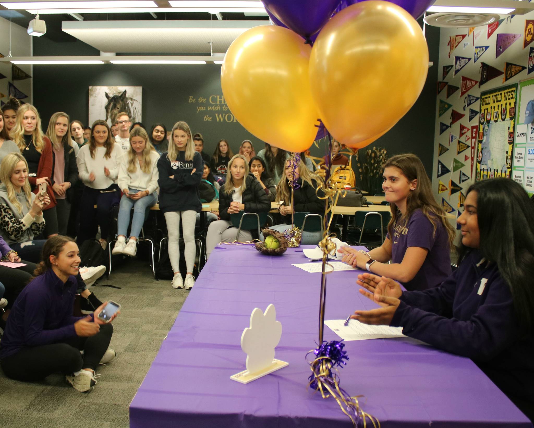 An overflowing crowd watches Jennifer Cummings and Adithi Anand commit to the University of Washington. Andy Nystrom/ staff photo