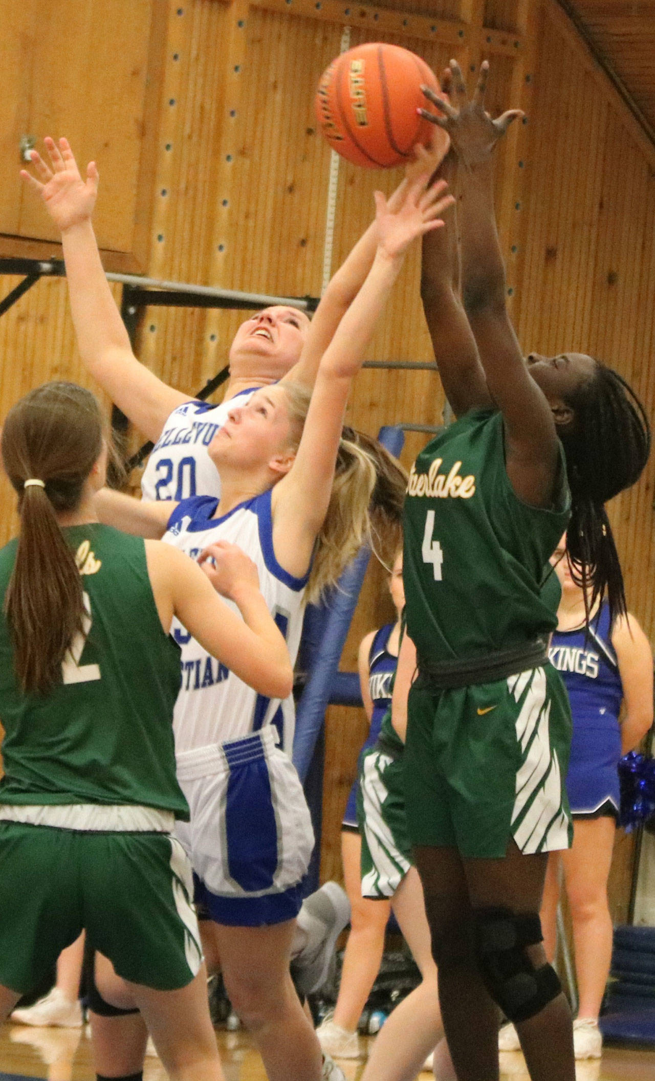 Overlake’s Meri Cosmos, right, battles for the ball with Bellevue Christian players on Dec. 10. Andy Nystrom/ staff photo