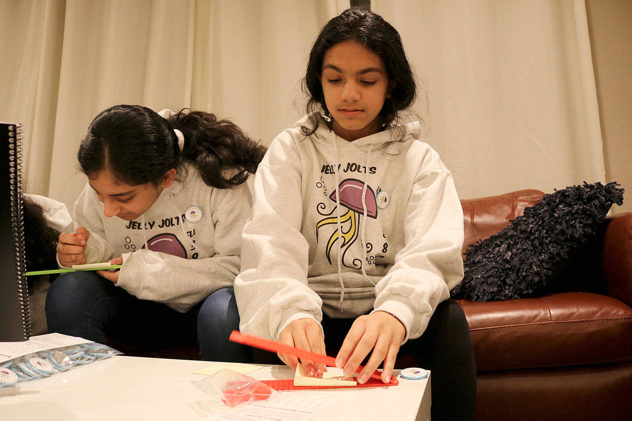 Anika Joshi, 12, uses a braille slate and stylus to write braille by hand. Stephanie Quiroz/staff photo