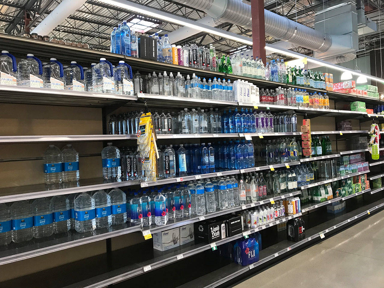 Sections of the water aisle at the Whole Foods in Kirkland were cleared out on March 15. Samantha Pak/staff photo