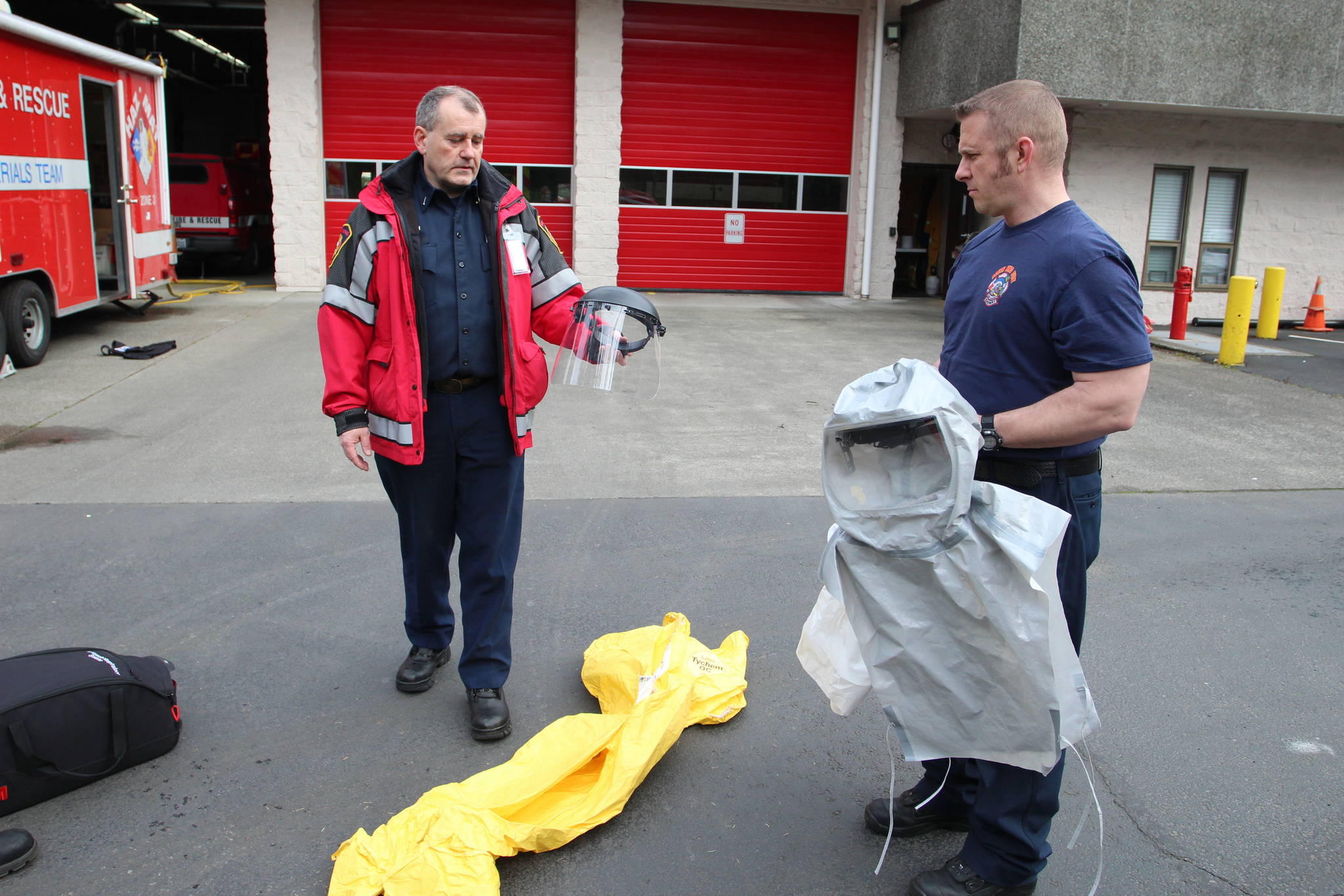 Lt. Greg Willett, left, and firefighter Eric Kiphart show the various types of personal protective equipment used by members of the hazmat team. Olivia Sullivan/staff photo