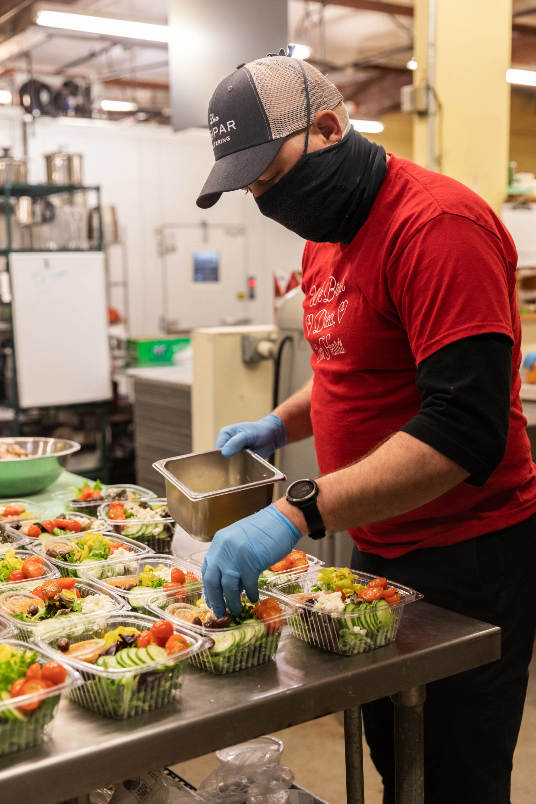 Dan Kiley, executive chef at Lisa Dupar Catering, prepares Mediterranean salads for Medic One Foundation’s Gratitude Meals program. Photo courtesy of Hannah Sheil