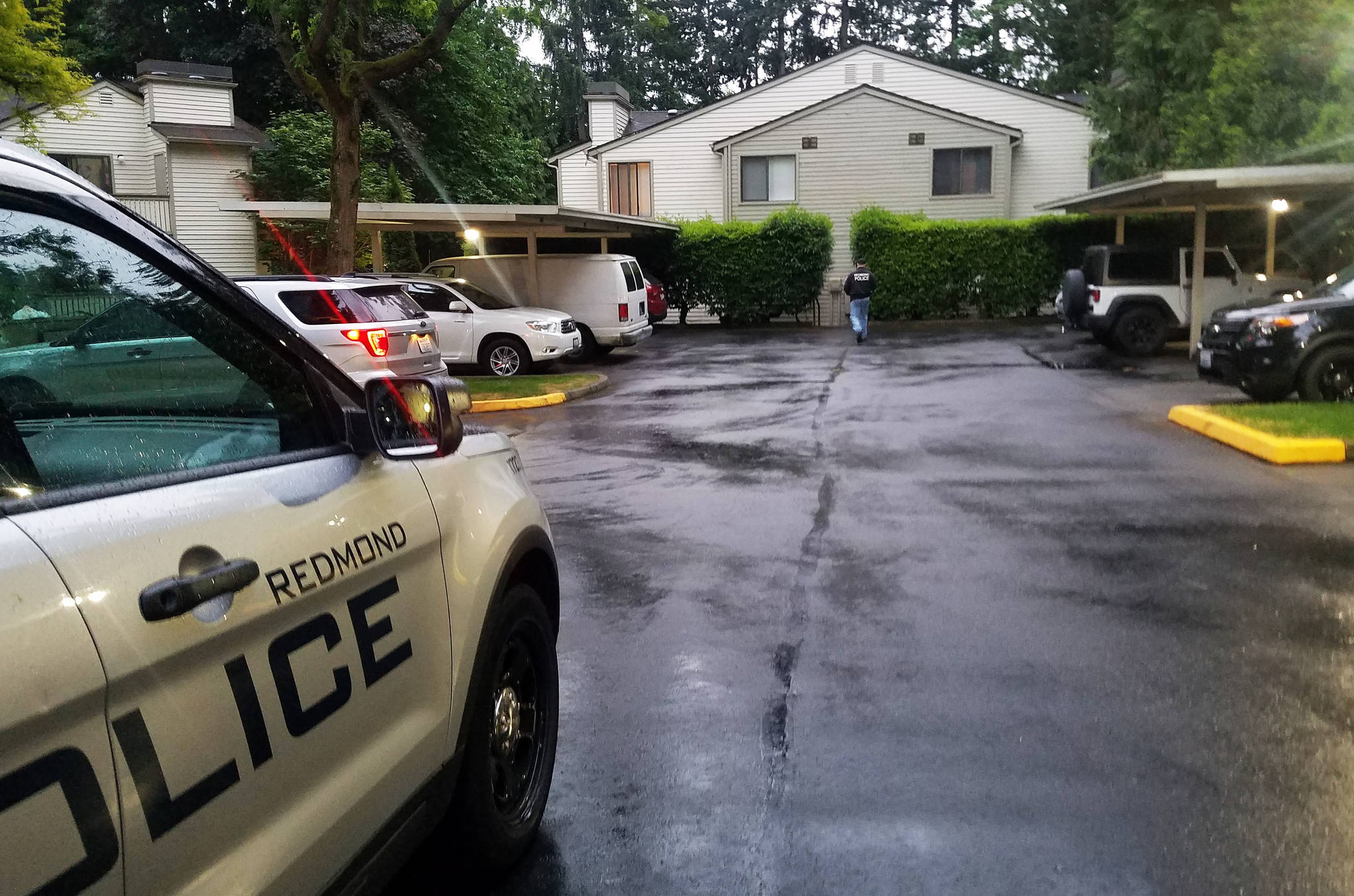 Detectives at the apartment where a 59-year-old Redmond resident was found dead, after an autopsy revealed a gunshot wound to the head, Saturday, May 16. Photo courtesy of Redmond Police Department.