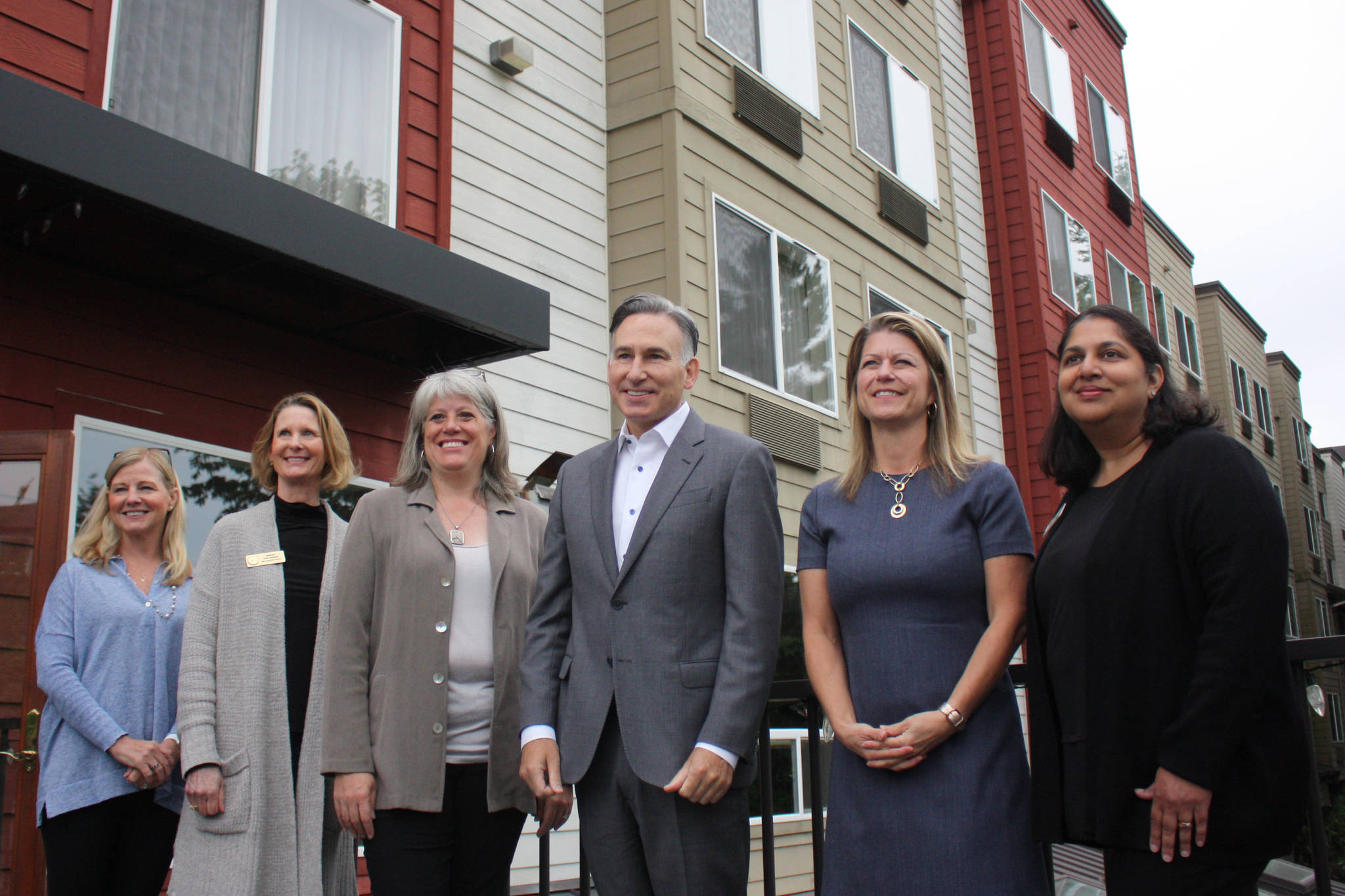 (left to right) Microsoft Philanthropies Director, Jane Broom, Sen. Patty Kuderer (D-Bellevue), King County Council member, Claudia Balducci, King County Executive, Dow Constantine, Redmond Mayor, Angela Birney, Redmond City Council member, Tanika Padhye (out of frame: Redmond City Council Member Jeralee Anderson) pose in front of newly acquired housing facility. (photo credit: Cameron Sheppard)