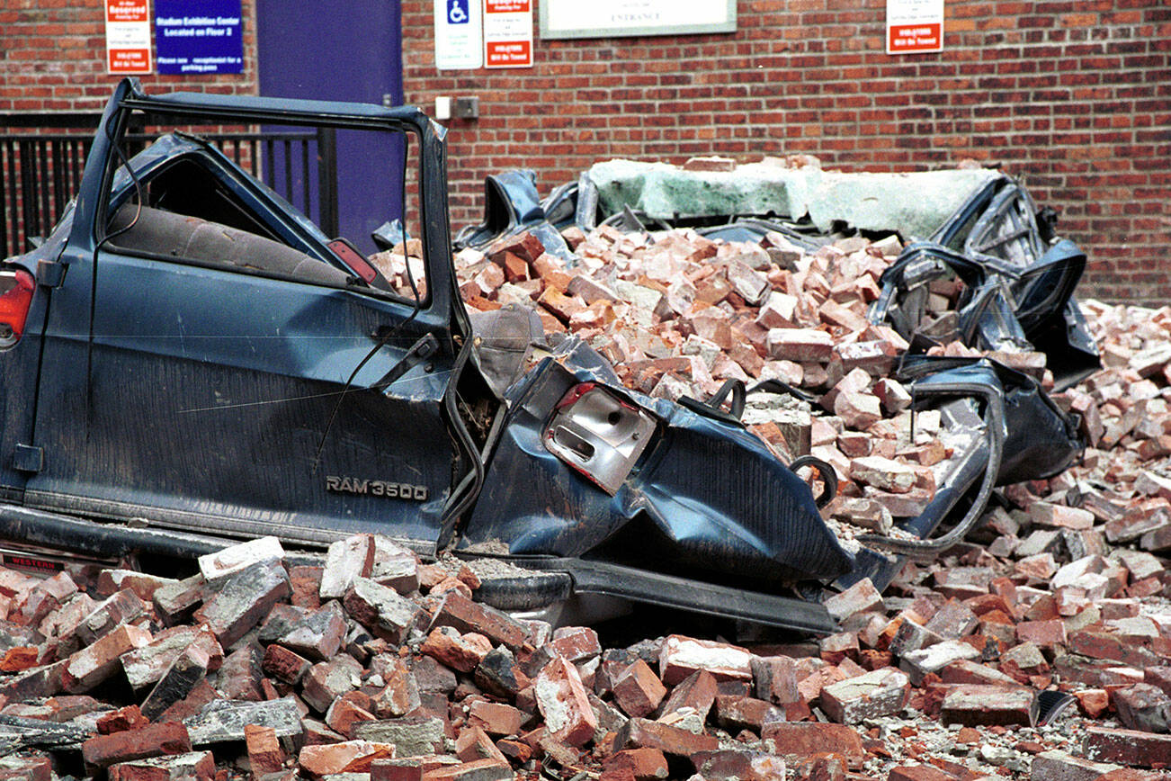A large van was crushed by earthquake debris in a Seattle parking lot in this photo taken March 4, 2001. FEMA News Photo by Kevin Galvin