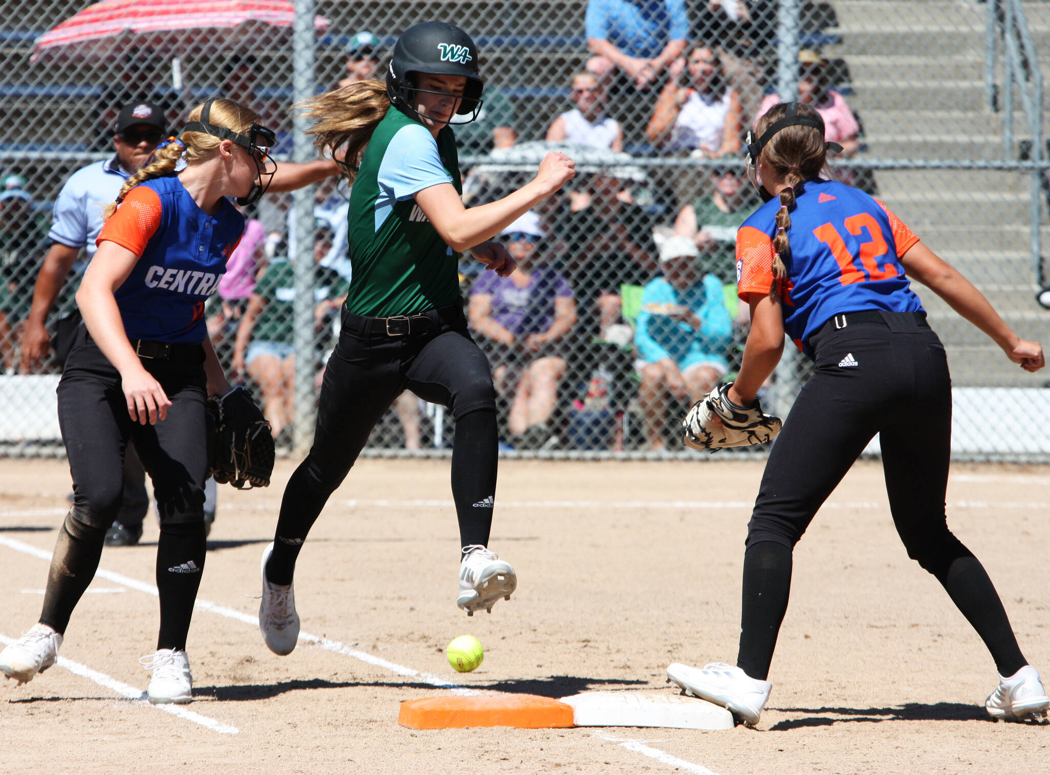 Redmond West Little League’s Ainsley Barcalow runs up the base line and is safe at first during today’s game at the Junior League Softball World Series at Everest Park in Kirkland. The Central team from Jenison, Michigan, won, 4-2, in the pool play matchup. Redmond represents Washington District 9. Andy Nystrom/ staff photo
