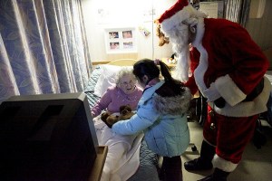 Santa and a helper from Washington Cathedral visit a senior home as part of the church’s Santa Conspiracy outreach.