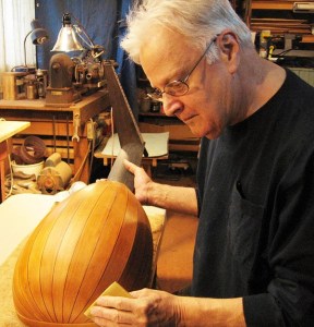 John Rollins builds an instrument in his workshop.