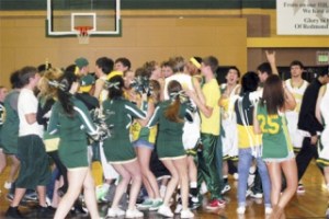 Redmond Superfans and players celebrate on the court after the Mustangs' 69-58 win over the Mountain View Thunder of Vancouver. Redmond plays top-ranked Federal Way in the opener of the Class 4A State Tournament this Wednesday at noon at the Tacoma Dome