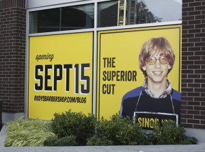 A young Bill Gates lets people know when the new Rudy's Barbershop in downtown Redmond will open.