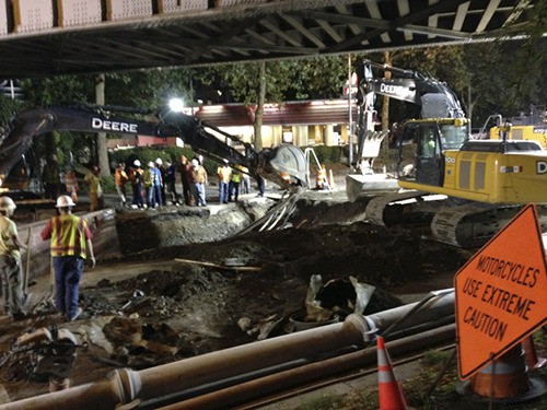 A Frontier repair crew works away on Redmond Way under the train trestle on Saturday night.