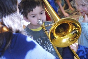 A student from Montessori Children's House tries his hand at the trombone.