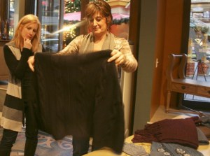 Louie Permelia owner Toni Forseth and employee Beth Anne Caldwell examine a sweater featured in the Indigenous Fall Style Tour. Louie Permelia has been in Redmond Town Center since the mall opened in 1997 and is a contemporary women's clothing boutique. The store has been carrying the Indigenous clothing line for about a year and a half.