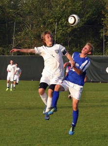 Bear Creek forward Mark Phillips (left) battles with La Conner midfielder Jack Borusinski for a header during Monday afternoon's nonleague matchup against the Braves. Phillips scored a goal in the Grizzlies' 2-0 shutout