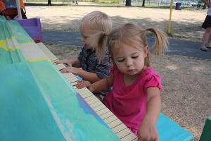 Two-and-a-half-year-old Jaedon Lewis (left) and 2-year-old Adaly Morris play the piano installed at Marymoor Park.