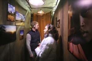 Heidi Best and Jeff Harcus look around at photos along the walls as they toured the “World Vision Experience: AIDS” exhibit at Overlake Christian Church on Saturday. The 3
