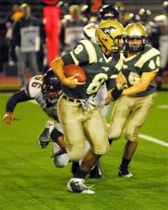 Redmond football 1: Redmond quarterback Michael Conforto eludes a diving tackle attempt by Issaquah's Jay Deines during the Eagles' 40-7 throttling of the Mustangs. Conforto scored the Mustangs' only touchdown.