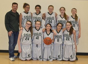 Evergreen Middle School’s girls varsity basketball team recently finished its season with an 8-0 record and district championship. This is the first time that any Evergreen girls basketball team has gone undefeated and it’s also the girls program’s first district title. Top row:  Coach Keith Yusko