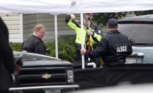 Redmond Police detectives investigate the crime scene of a murder-suicide in a parking lot at the Archstone Redmond Campus Apartments on Tuesday. Officals say a man fired several shots