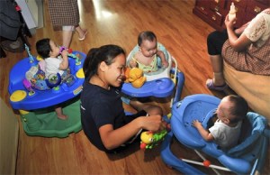 Lanfen Kaplan plays with children from a foster home in Beijing during her recent trip to China. Kaplan was one of three Redmond High School students who made the long trip to share time and loving care with children at orphanages and private foster homes in Beijing and Xian.