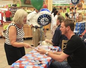 Seattle Mariners relief pitcher Mark Lowe signs an autograph for Ruth Ashburn