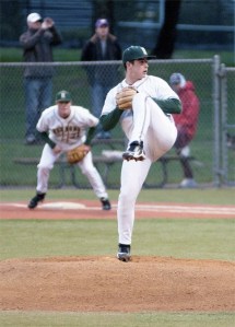 Redmond starting pitcher Dylan Davis winds up in the second inning of the Mustangs' 5-0 win against Eastlake on Tuesday night at Hartman Park as first baseman Zach Abbruzza looks on in the background. Davis pitched a gem