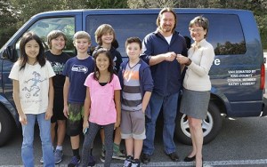 King County Council member Kathy Lambert hands the keys to a retired County Vanpool Van to Zach Wenman