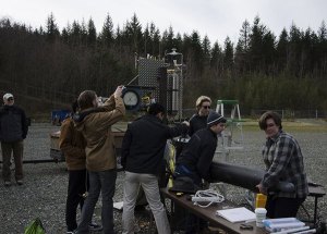 STEM High School students work together on a rocket that they will enter into the Intercollegiate Rocket Engineering Competition in June. The group conducted the third hot fire test for the rocket.