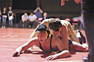 Redmond senior Joe Glass (top) takes down Inglemoor sophomore Josh Koukal during the 4A Kingco Championships on Feb. 12. Glass