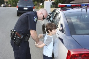 Redmond Police officer Jesse Bollerud handcuffs Bar Ben-zvi
