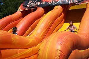 A youngster goes down an inflatable slide in the Kids Zone at last year's Derby Days.